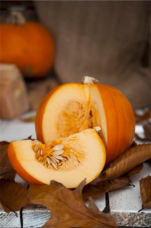 squash (vegetable) - A sliced pumpkin on autumnal leaves Stock Photo - Premium Royalty-Free, Code: 659-06670991
