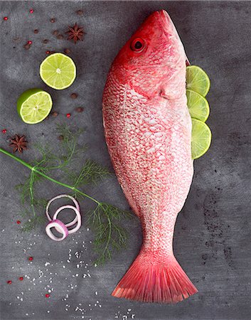 red snapper - Raw Red Snapper Stuffed with Lime Surrounded by Seasonings Stock Photo - Premium Royalty-Free, Code: 659-06671062