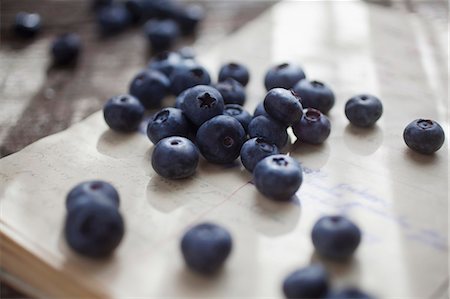 fruits in wooden table - Blueberries on a sheet of paper covered in writing Stock Photo - Premium Royalty-Free, Code: 659-06902017