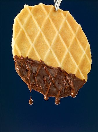 simsearch:659-06188604,k - Waffled dipped in melted chocolate Stock Photo - Premium Royalty-Free, Code: 659-06902340