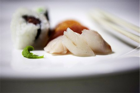 simsearch:659-07610354,k - Uramaki and nigiri sushi; sashimi and wasabi paste to the front Stock Photo - Premium Royalty-Free, Code: 659-06902789