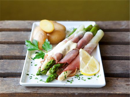 simsearch:659-06901837,k - Asparagus wrapped in ham with Hollandaise sauce and potatoes Stock Photo - Premium Royalty-Free, Code: 659-06903929