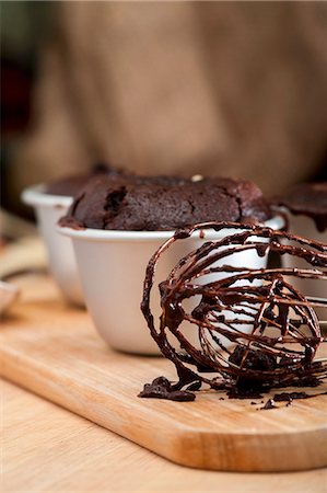 Chocolate melting middle pudding; in the foreground, an egg whisk with remnants of the mixture Stock Photo - Premium Royalty-Free, Code: 659-06903988