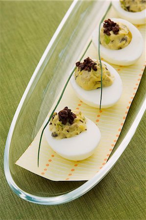 egg dish - Eggs a la russe, garnished with chopped olives, on a platter Stock Photo - Premium Royalty-Free, Code: 659-07026761
