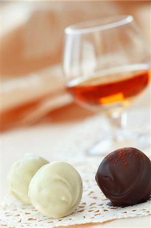 simsearch:841-06805239,k - Two White Chocolate and a Chocolate Cinnamon Truffle; Snifter of Scotch Stock Photo - Premium Royalty-Free, Code: 659-07026877