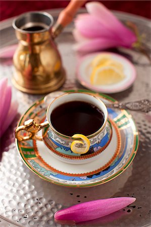 A Cup of Coffee with a Lemon Twist and a Pink Flower on a Silver Tray Stock Photo - Premium Royalty-Free, Code: 659-07027041