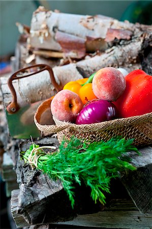 Fresh Veggies and Fruit in a Basket; Bunch of Fresh Dill; On a Woodpile Stock Photo - Premium Royalty-Free, Code: 659-07027081