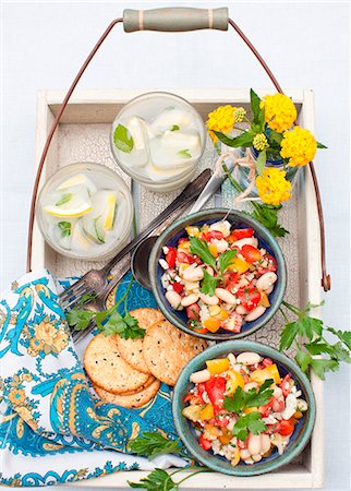 special occasion - Two Bowls of Cherry Tomato and Bean Salad with Feta Cheese; Crackers and Drinks on a Tray Stock Photo - Premium Royalty-Free, Code: 659-07027091