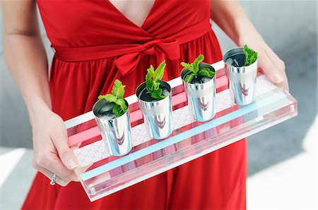 A Woman Carrying a Tray of Mint Drinks in Small Cups Stock Photo - Premium Royalty-Free, Code: 659-07027130