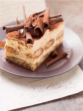 simsearch:659-06307822,k - A piece of tiramisu cake topped with rolls of chocolate Stock Photo - Premium Royalty-Free, Code: 659-07027216