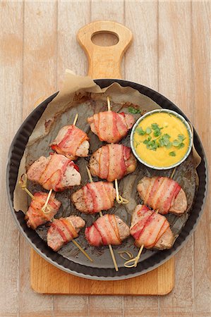 simsearch:659-07739811,k - Pork fillet wrapped in bacon with peanut curry sauce and corn Stock Photo - Premium Royalty-Free, Code: 659-07027272