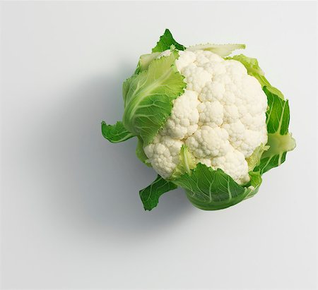 A cauliflower on a white surface Stock Photo - Premium Royalty-Free, Code: 659-07028145