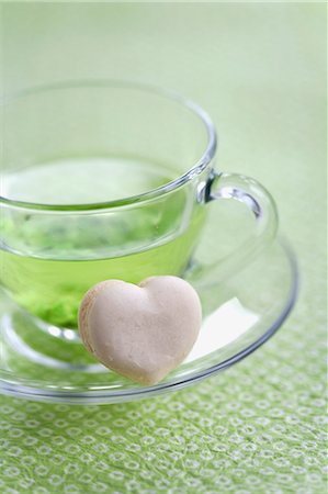 simsearch:659-06903190,k - A heart-shaped vanilla macaroon with a cup of green tea Stock Photo - Premium Royalty-Free, Code: 659-07028161