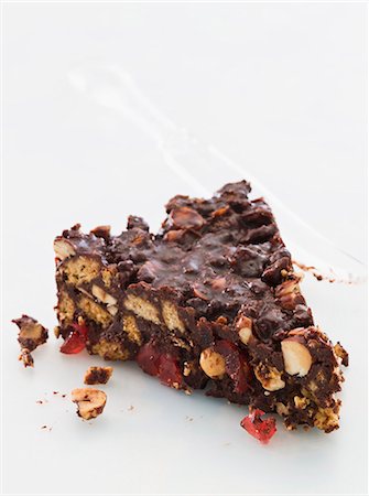 simsearch:659-01848790,k - A slice of chocolate biscuit cake with glacÈ cherries and nuts Stock Photo - Premium Royalty-Free, Code: 659-07068636