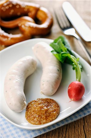 soft pretzel food photography - Veal sausages with sweet mustard, radishes and a pretzel (Bavaria) Stock Photo - Premium Royalty-Free, Code: 659-07068835