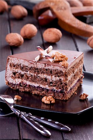 A slice of walnut layer cake with chocolate curl Stock Photo - Premium Royalty-Free, Code: 659-07068933