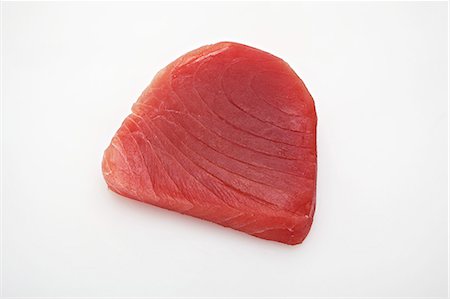 Raw tuna steak on a white surface Stock Photo - Premium Royalty-Free, Code: 659-07069559