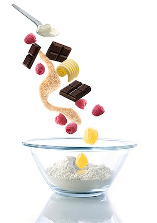 Ingredients for chocolate muffins with raspberries, falling into a glass bowl Stock Photo - Premium Royalty-Free, Code: 659-07069884