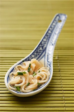 A spoon of noodle soup from China with chopped chives Stock Photo - Premium Royalty-Free, Code: 659-07596997