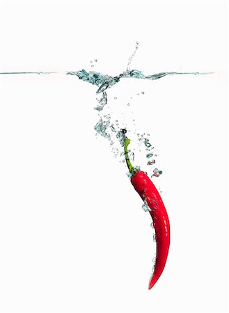 simsearch:659-06154334,k - A red chilli pepper falling into water Stock Photo - Premium Royalty-Free, Code: 659-07597248