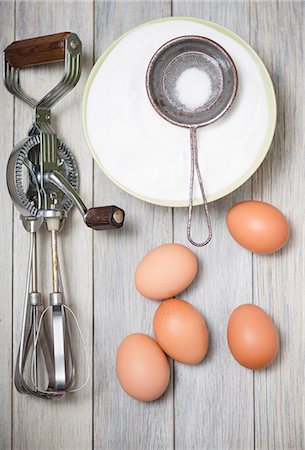 An old rotary hand whisk, eggs and sugar Stock Photo - Premium Royalty-Free, Code: 659-07597655