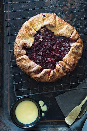 simsearch:659-07069181,k - Raspberry galette (a rustic tart) on a cooling rack, and a pot of custard Stock Photo - Premium Royalty-Free, Code: 659-07597930