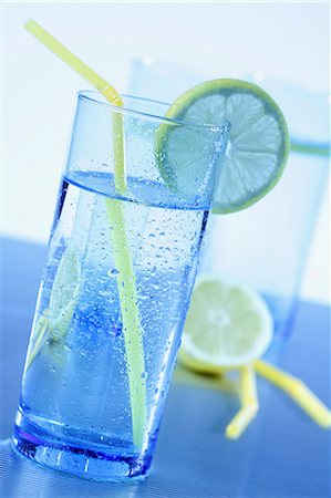simsearch:659-06495307,k - Blue glasses with water, lemons slices and yellow straws Stock Photo - Premium Royalty-Free, Code: 659-07598015