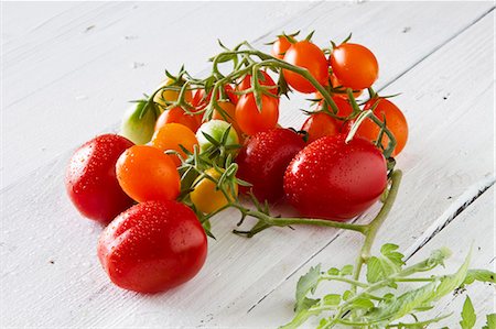 Assorted tomatoes on a white-painted wooden table Stock Photo - Premium Royalty-Free, Code: 659-07598334