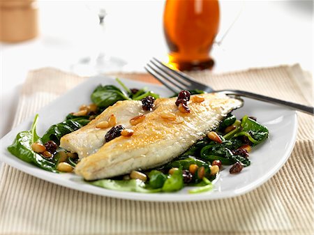 simsearch:659-06372915,k - pan fried sea bass with wilted spinach, roasted pine nuts and sultanas Stock Photo - Premium Royalty-Free, Code: 659-07598398