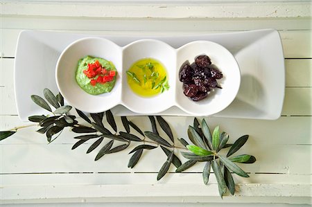 Green tahini, olive oil and black olives Stock Photo - Premium Royalty-Free, Code: 659-07599033