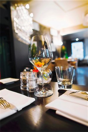 put on a table - interior of the restaurant, focus on a wine glass Stock Photo - Premium Royalty-Free, Code: 659-07599344