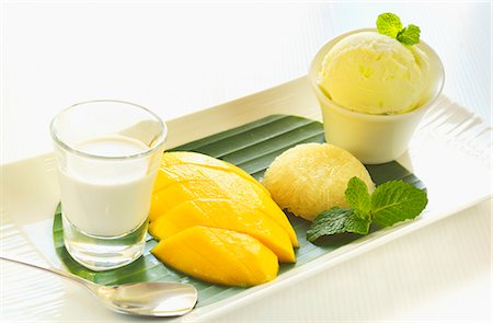 Mango, sticky rice, lemon ice cream and coconut milk (Thailand) Stock Photo - Premium Royalty-Free, Code: 659-07609626