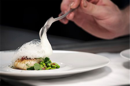 pulse - Chef plating up fish and broad bean dish during service at working restaurant Stock Photo - Premium Royalty-Free, Code: 659-07609761