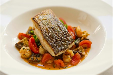 Seabass fillet with tomatoes, mushrooms and lychees Stock Photo - Premium Royalty-Free, Code: 659-07610286