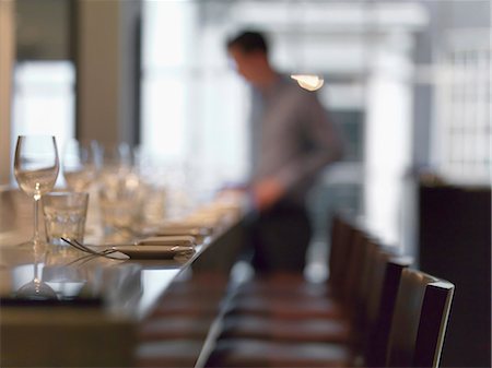 setting table - A row of chairs at a restaurant table Stock Photo - Premium Royalty-Free, Code: 659-07739183