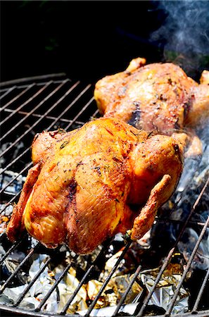 Two chickens on a smoking barbecue Stock Photo - Premium Royalty-Free, Code: 659-07958278