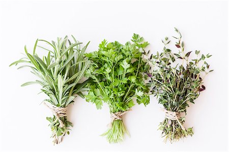 Three bunches of fresh herbs: rosemary, coriander and thyme Stock Photo - Premium Royalty-Free, Code: 659-07958930