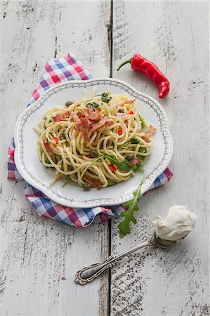 simsearch:659-07597225,k - Spaghetti with bacon, chilli, mascarpone, rocket and capers Stock Photo - Premium Royalty-Free, Code: 659-07959012