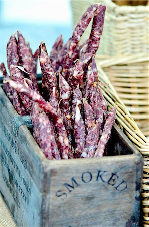 Mini salamis in a wooden crate at a market Stock Photo - Premium Royalty-Free, Code: 659-07959267