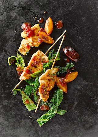 skewered - Chicken breast skewers with savoy cabbage, plums, bacon, shredded herb pancakes and tomato sauce Stock Photo - Premium Royalty-Free, Code: 659-07959482