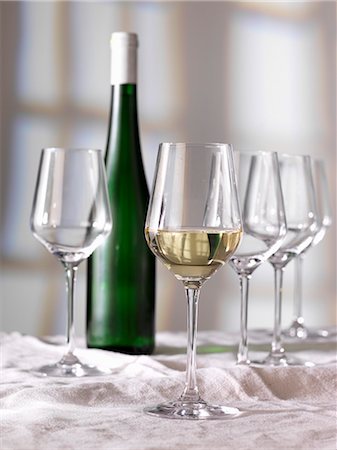 simsearch:659-06186663,k - A glass of white wine, a bottle of wine and empty glasses Stock Photo - Premium Royalty-Free, Code: 659-07959508