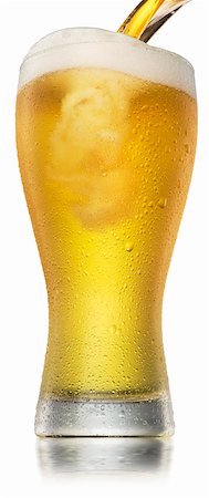 A beer being poured into a glass with condensation Stock Photo - Premium Royalty-Free, Code: 659-07959500