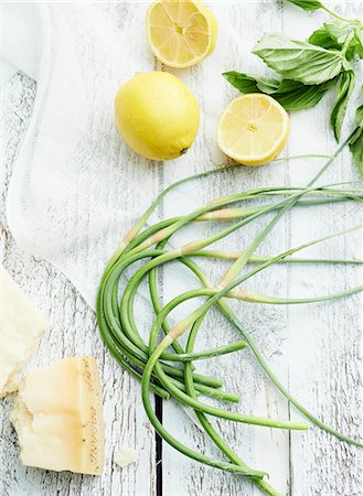 fruits in wooden table - Garlic chives, lemons and Parmesan on wooden table Stock Photo - Premium Royalty-Free, Code: 659-07959703