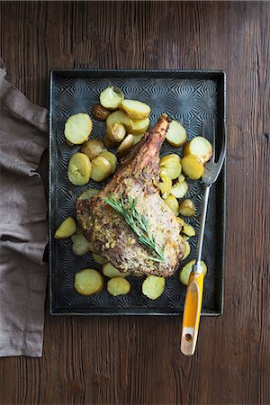 roasted (meat) - Roasted leg of lamb with potatoes and rosemary Stock Photo - Premium Royalty-Free, Code: 659-08148046