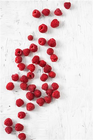 raspberry - Raspberries on a white surface Stock Photo - Premium Royalty-Free, Code: 659-08418960