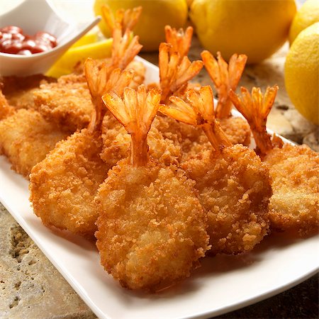 seafood - Breaded fried prawns with lemons Stock Photo - Premium Royalty-Free, Code: 659-08419101