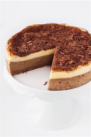 simsearch:659-06185283,k - Sliced tiramisu cheesecake on a cake stand Stock Photo - Premium Royalty-Free, Code: 659-08419461