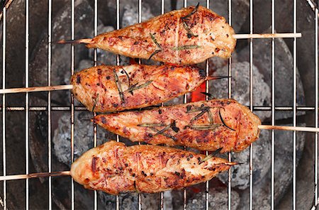 skewer - Chicken skewers on a barbecue (seen from above) Stock Photo - Premium Royalty-Free, Code: 659-08419913