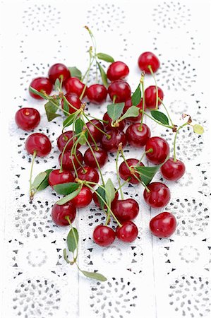 simsearch:659-06373112,k - Sour cherries with leaves on a lace surface Stock Photo - Premium Royalty-Free, Code: 659-08419953