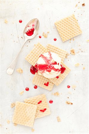 simsearch:659-08418689,k - A scoop of ice cream on wafer biscuits with a red fruit sauce Stock Photo - Premium Royalty-Free, Code: 659-08420035